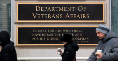 People walk past the Department of Veterans Affairs headquarters in Washington, D.C., on March 6.