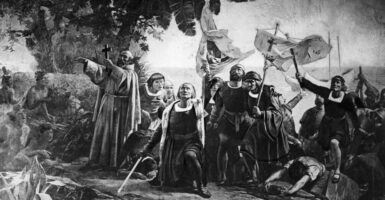 Black and white rendering of a painting of Christopher Columbus, kneeling, surrounded by fellow travelers, after landing.