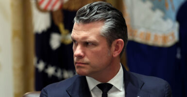 Close-up of Pete Hegseth looking intently to his right.