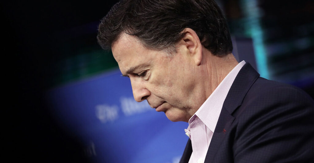 Profile shot of James Comey looking down.