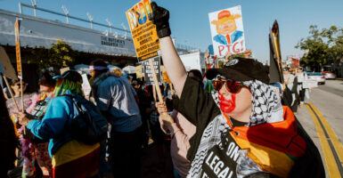 A woman raises her fist while marching during an International Women's Day protest in Los Angeles on March 8.