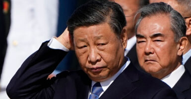 Xi Jinping, with his hand against the back of his head.