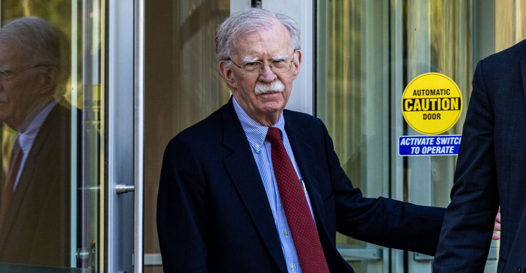 John Bolton exiting a courthouse.