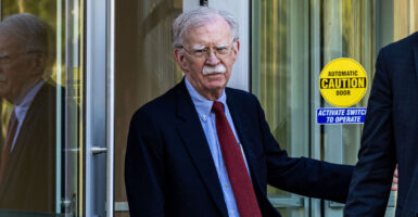 John Bolton exiting a courthouse.