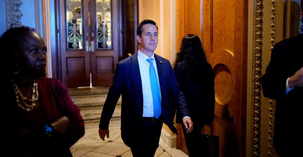 Sen. Bernie Moreno looks forward as he walks through the Senate.