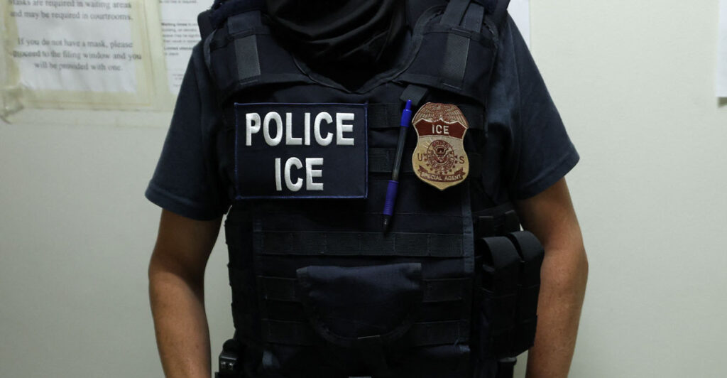 An ICE agent waits in a hallway outside of a courtroom in New York City on July 17.