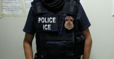 An ICE agent waits in a hallway outside of a courtroom in New York City on July 17.