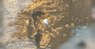 Overhead shot of alleged Hamas members burying a body.