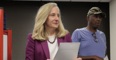 Abigail Spanberger in purple holds a ballot.