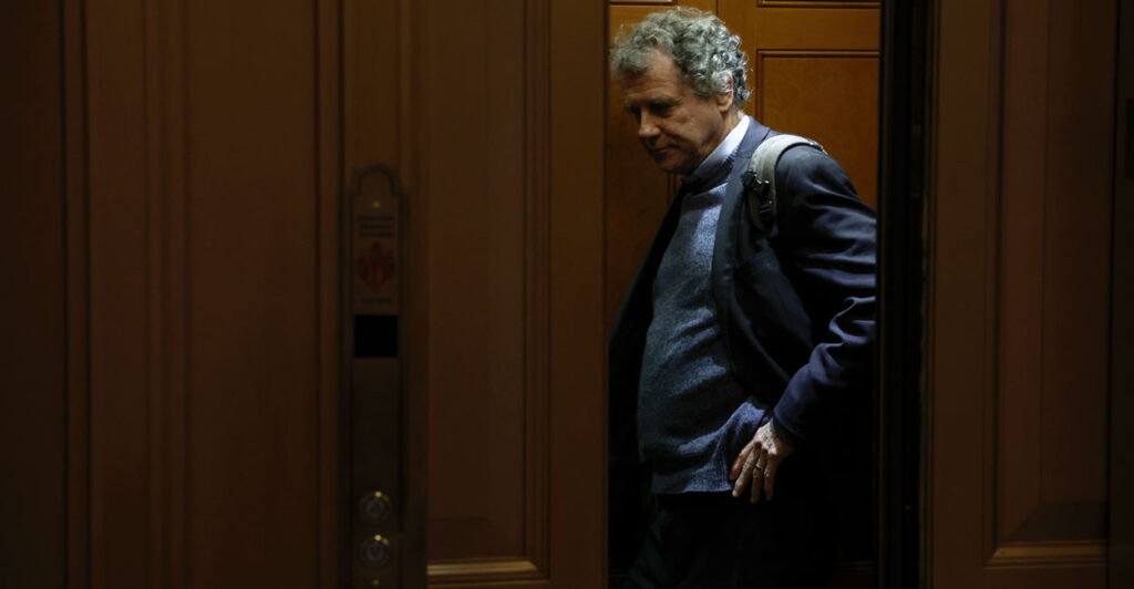 Former Sen. Sherrod Brown stands in an elevator.