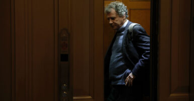 Former Sen. Sherrod Brown stands in an elevator.