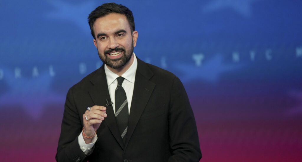 Democratic mayoral nominee Zohran Mamdani speaks during a mayoral debate at Rockefeller Center, looking directly at the camera.