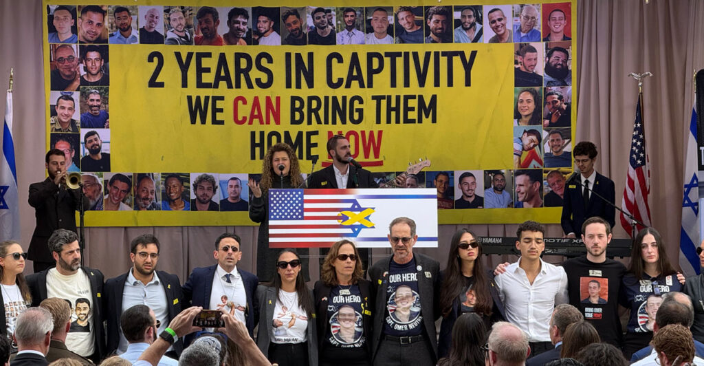 Former hostages and hostage families stand arm in arm at an event Tuesday in Washington, D.C., to mark the second anniversary of the Oct. 7, 2023, terrorist attack on Israel by Hamas.