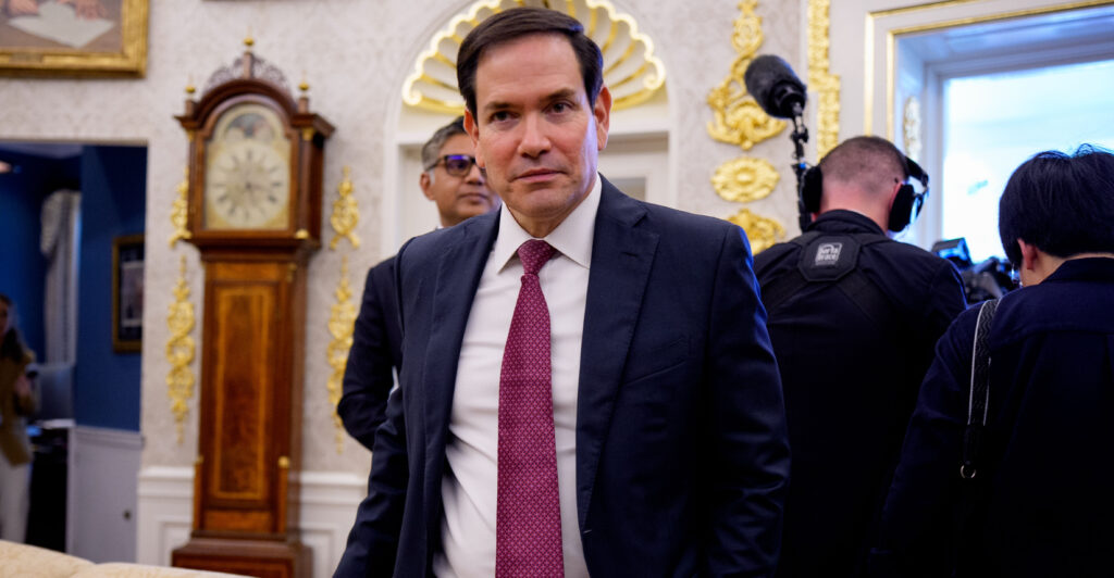 Secretary of State Marco Rubio walks though the Oval Office.
