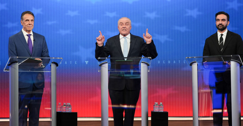 Republican nominee Curtis Sliwa (C) speaks alongside Independent nominee former, New York Gov. Andrew Cuomo (L) and Democratic nominee Zohran Mamdani during a mayoral debate.