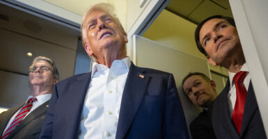 Low angle shot of President Trump and Marco Rubio as they talk to reporters aboard Air Force One.