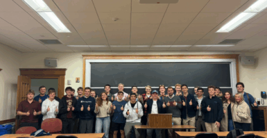 Members of the Boston College Republicans pose with guest speaker Nick Solheim giving thumbs up.