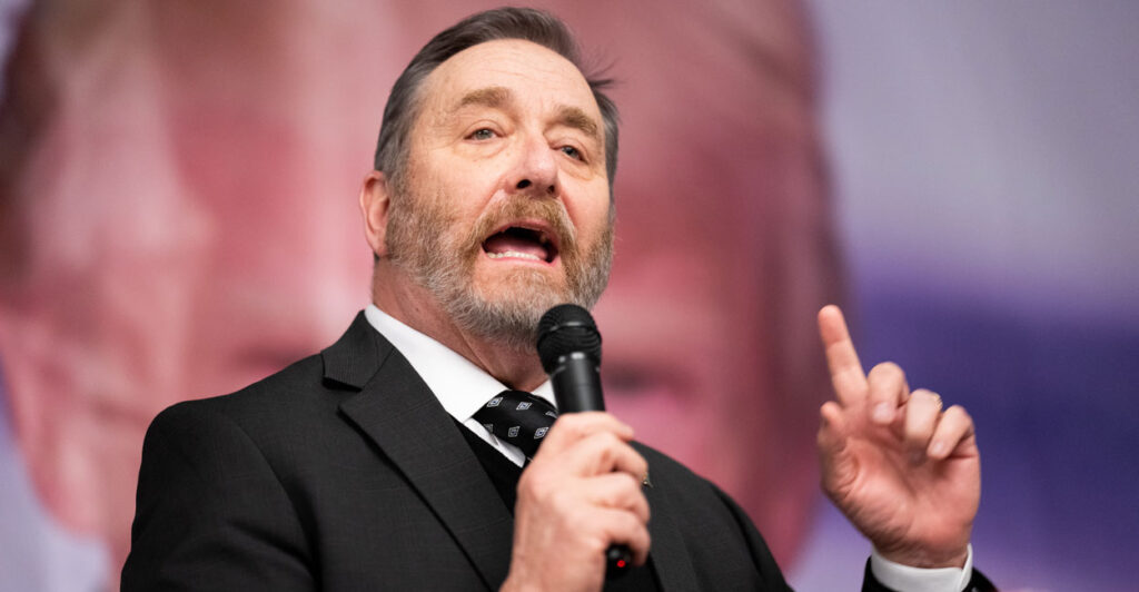 Ohio Attorney General Dave Yost gestures upwards as he speaks during an event.