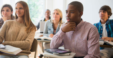 Teenage students listening in classroom