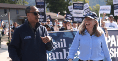 Jay Jones and Abigail Spanberger leading a parade.