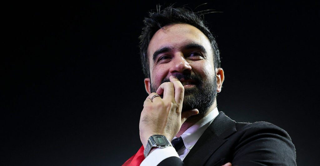 Close-up of Zohran Mamdani with his hand at his face.