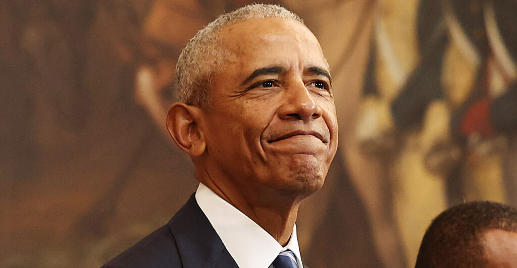 Barack Obama in a suit with a closed smile