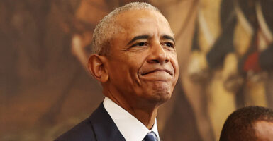 Barack Obama in a suit with a closed smile