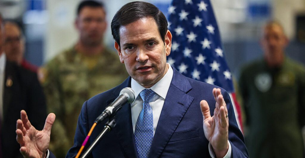Secretary of State Marco Rubio speaking into a microphone