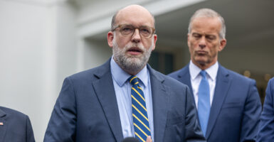 OMB Director Russ Vought speaks to reporters outside the White House.
