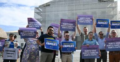 Demonstrators pose for a photo as they protest against conversion therapy outside the US Supreme Court