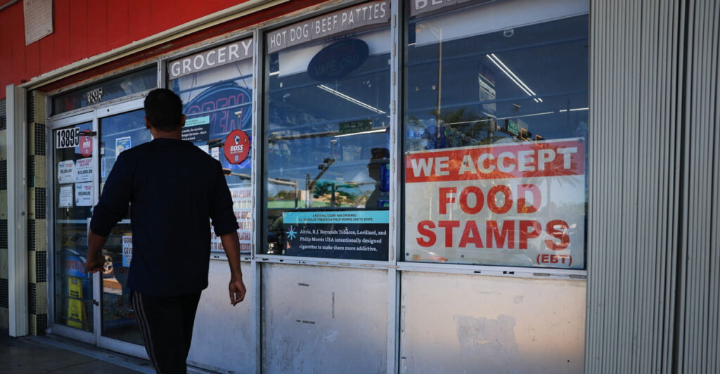A “We Accept Food Stamps” sign hangs in the window of a grocery store on Friday in Miami, Florida. The food stamp program is now known as the Supplemental Nutrition Assistance Program.