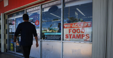 A “We Accept Food Stamps” sign hangs in the window of a grocery store on Friday in Miami, Florida. The food stamp program is now known as the Supplemental Nutrition Assistance Program.