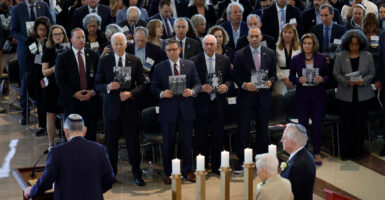 From left: Then-President Joe Biden; House Speaker Mike Johnson and House Majority Leader Steve Scalise, both R-La.; and House Minority Leader Hakeem Jeffries, D-N.Y., hold photos of victims of the Holocaust during the U.S. Holocaust Memorial Museum's annual Days of Remembrance ceremony at the Capitol on May 7, 2024.