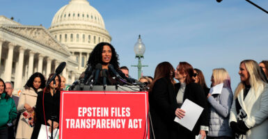 Lisa Phillips stands at a podium and looks to her left as she speaks during a news conference.