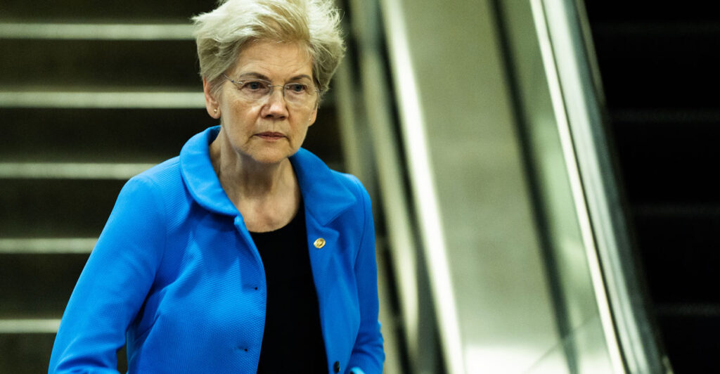 Sen. Elizabeth Warren, D-Mass., steps off a down escalator at the Capitol.