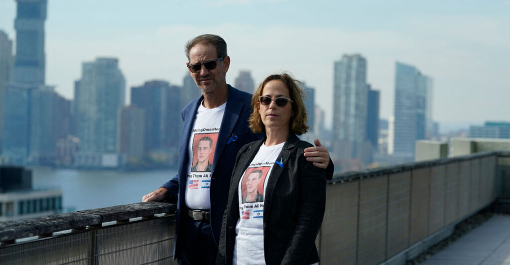 Ronen and Orna Neutra, parents of Omer Neutra, pose with the New York skyline behind them.