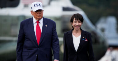 Donald Trump walks with Japanese Prime Minister Sanae Takaichi.