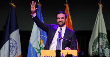 Zohran Mamdani waves to crowd at victory party.