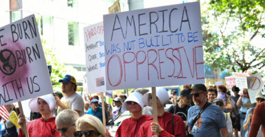 Protesters in "Handmaiden's Tale" costumes take part in Seattle protest.