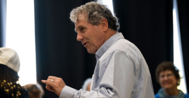 Sherrod Brown turns as he addresses a crowd.