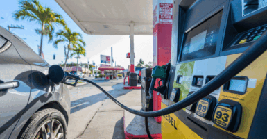 Car refueling at a gas station on a sunny morning.