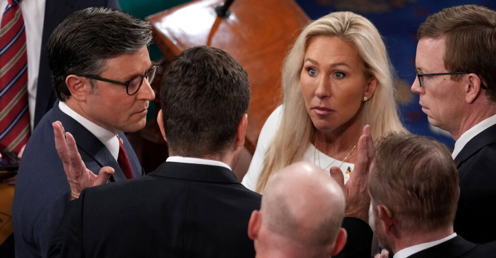 Speaker of the House Mike Johnson, R-La, and Rep. Marjorie Tayler Greene, R-Ga., talk with fellow Representatives.