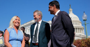Rep. Marjorie Taylor Greene, R-Ga., speaks with Rep. Thomas Massie, R-Ky., and Rep. Ro Khanna, D-Calif., during a news conference.