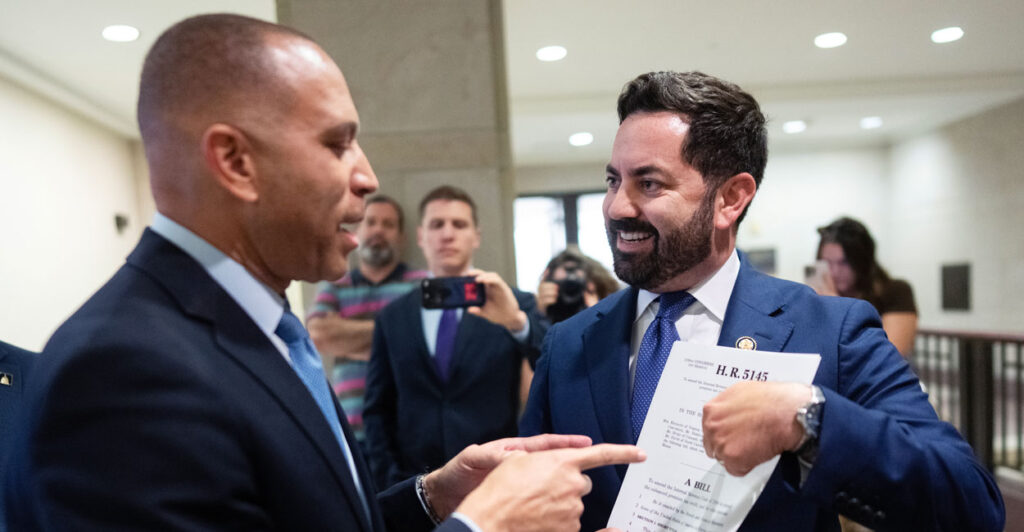 House Minority Leader Hakeem Jeffries and Republican House member Mike Lawler from New York argue in the capitol.