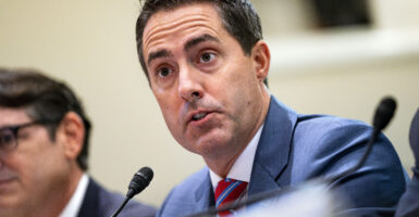 Ohio Secretary of State Frank LaRose speaks at a microphone from his seat.