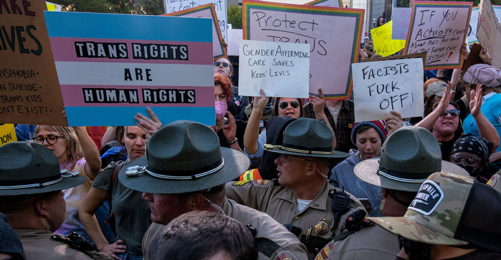 Transgender activists protesting in favor of "gender-affirming care." Activist pressure citing the SPLC got a nationwide body to cancel doctor education courses skeptical of "gender-affirming care."