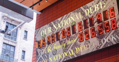 A federal debt clock hangs on a wall.