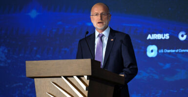 FCC Chair Brendan Carr speaks in front of a blue background.