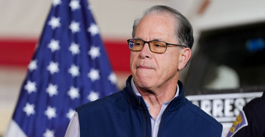 Indiana Gov. Mike Braun in blue vest jacket speaks at press conference.
