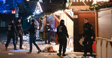 Police investigate in the aftermath of a terrorist attack on a German Christmas market.